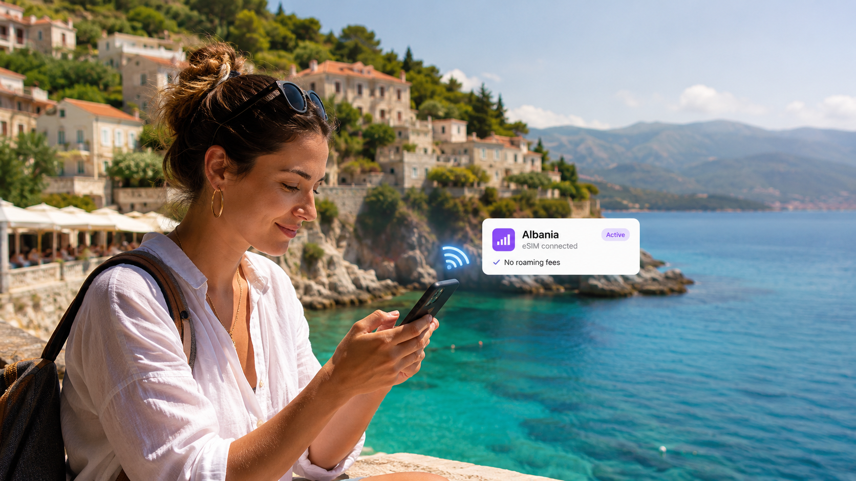 Traveler using a smartphone with an eSIM in Albania to stay connected without roaming fees
