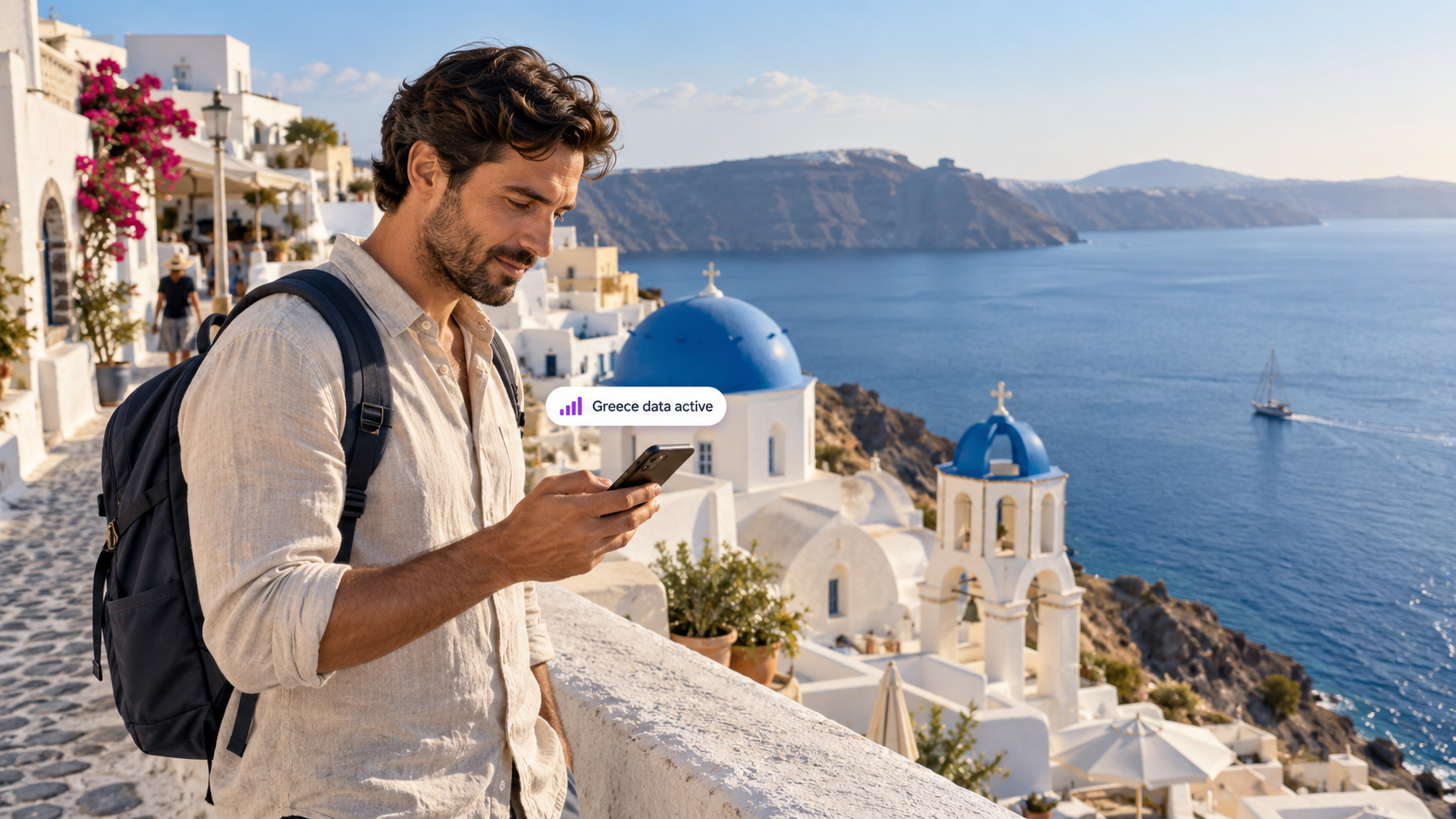 A traveler uses a smartphone in Oia, Santorini, overlooking blue-domed churches and the Aegean Sea, illustrating easy mobile connectivity with a duasim travel eSIM in Greece.