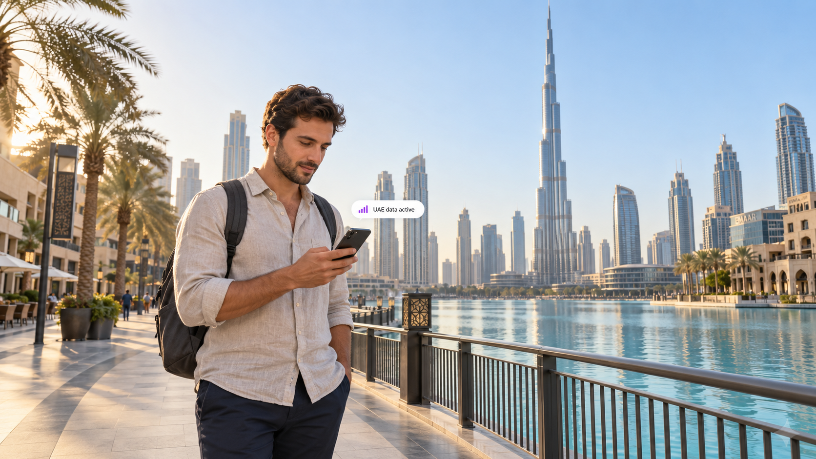 A traveler uses a smartphone on Dubai’s waterfront with the Burj Khalifa in the background, illustrating easy mobile connectivity with a duasim travel eSIM in the UAE.
